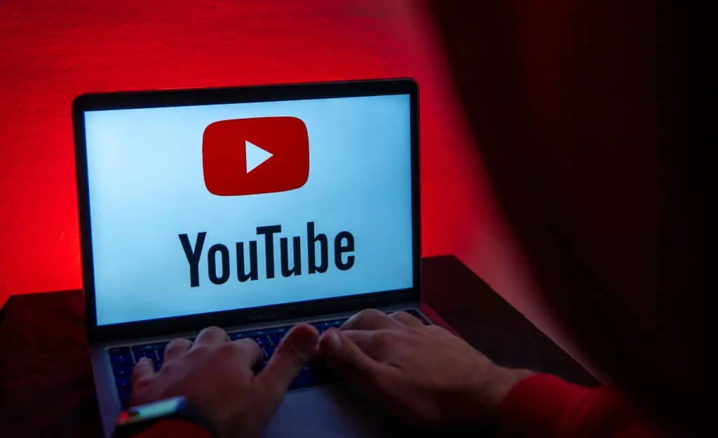 YouTube headquarters with policy update announcement banner