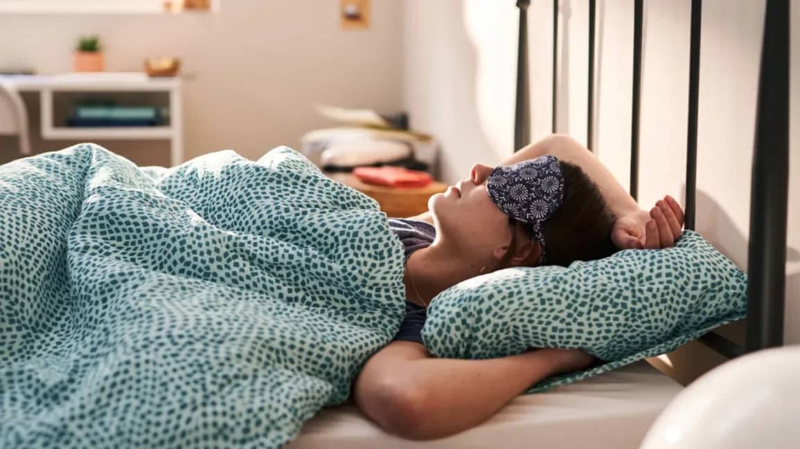 A serene bedroom setup with a dark, quiet environment optimized for a good night's sleep.