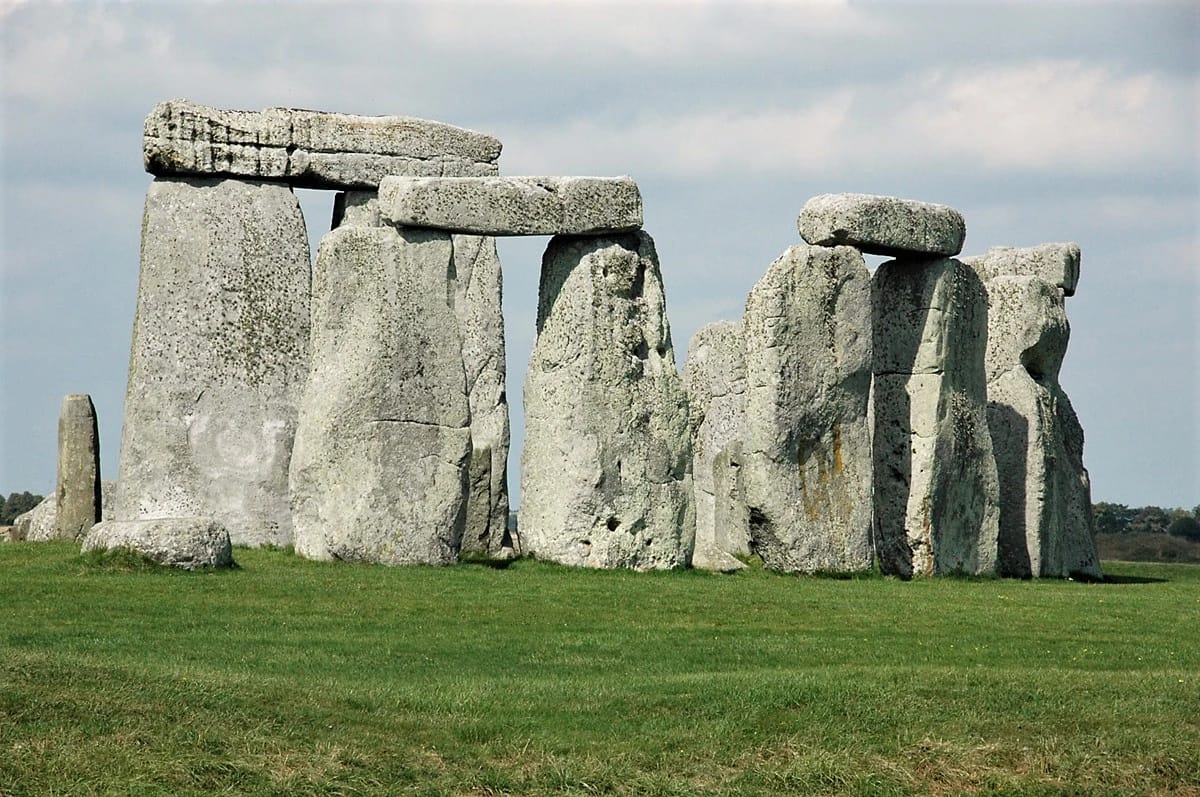 A row of towering menhirs stretching across the landscape at Carnac, representing the ancient Alignement de Kermario.