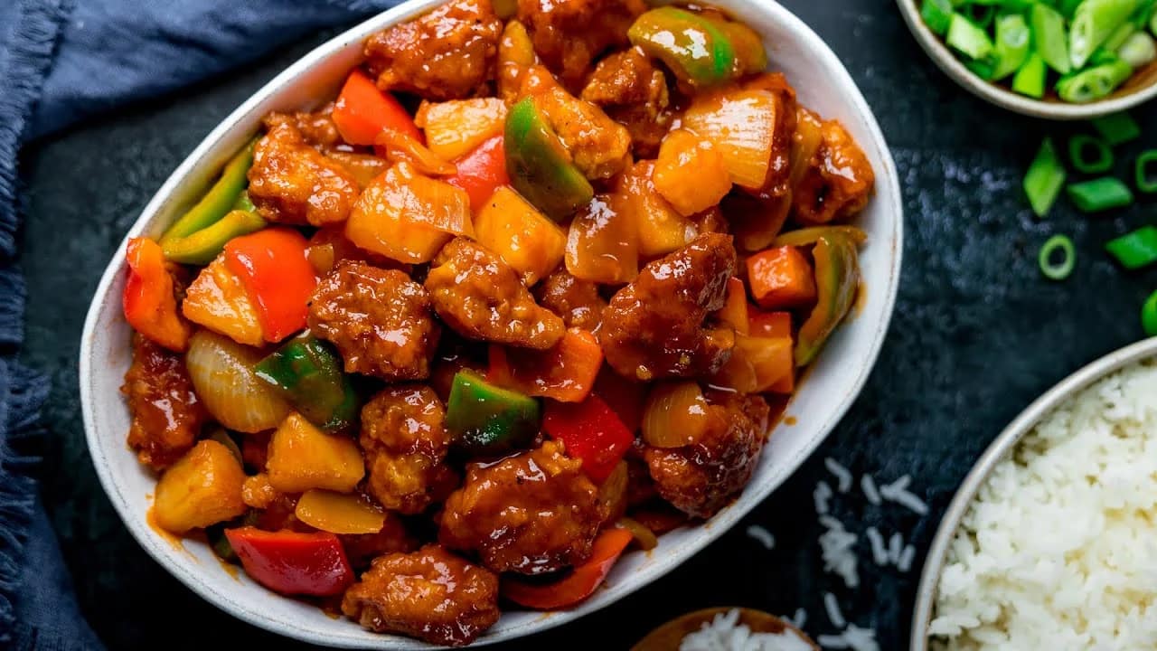 Close-up of Sweet and Sour Pork with a glossy sweet and tangy sauce 