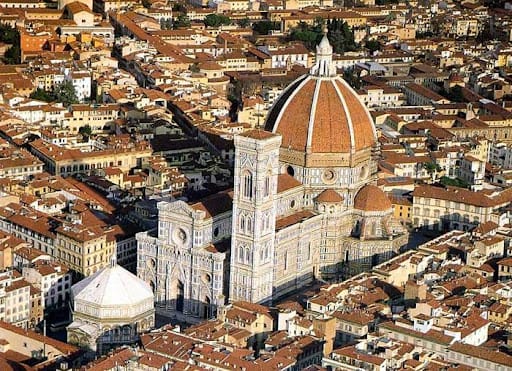 Interior of the Cathedral of Santa Maria del Fiore showcasing detailed frescoes and stained glass windows. 