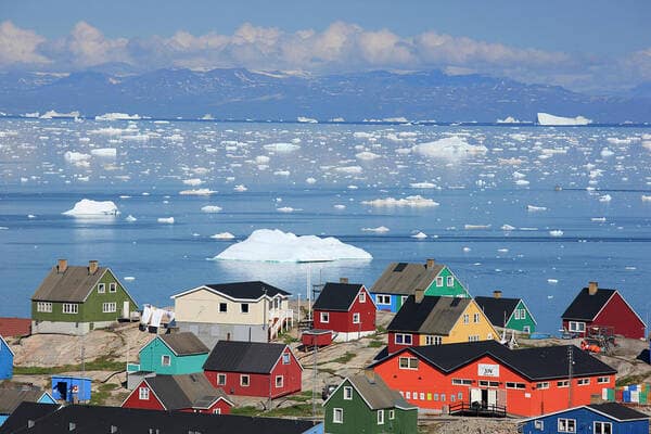 Majestic icebergs floating in Disko Bay under the midnight sun