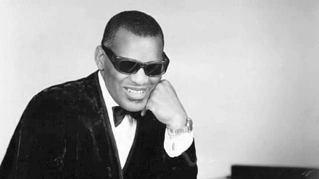 Ray Charles collaborating with Willie Nelson during a live performance. 