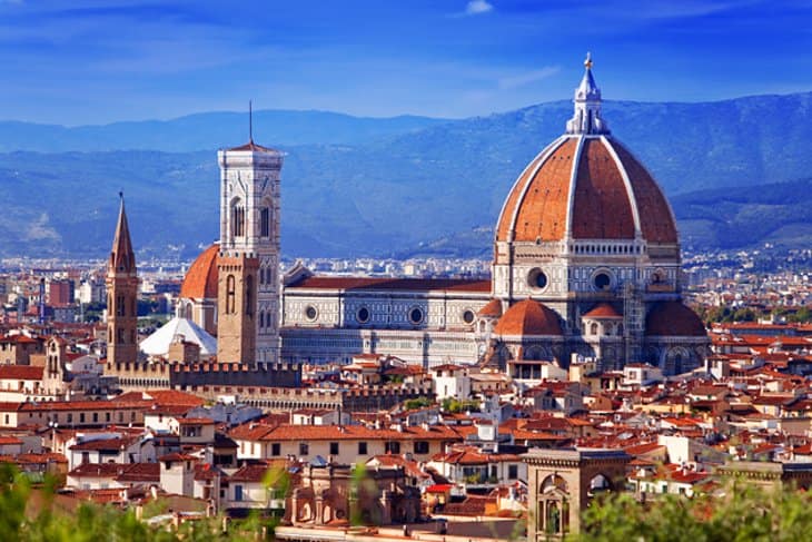 The intricate facade of the Cathedral of Santa Maria del Fiore, adorned with statues and marble work. 