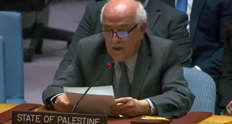 Demonstrators holding signs advocating for Palestinian recognition at the UN, showcasing global activism on the issue. 