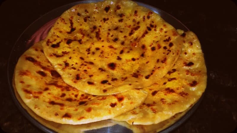 Golden Bobbatlu served warm with a drizzle of ghee