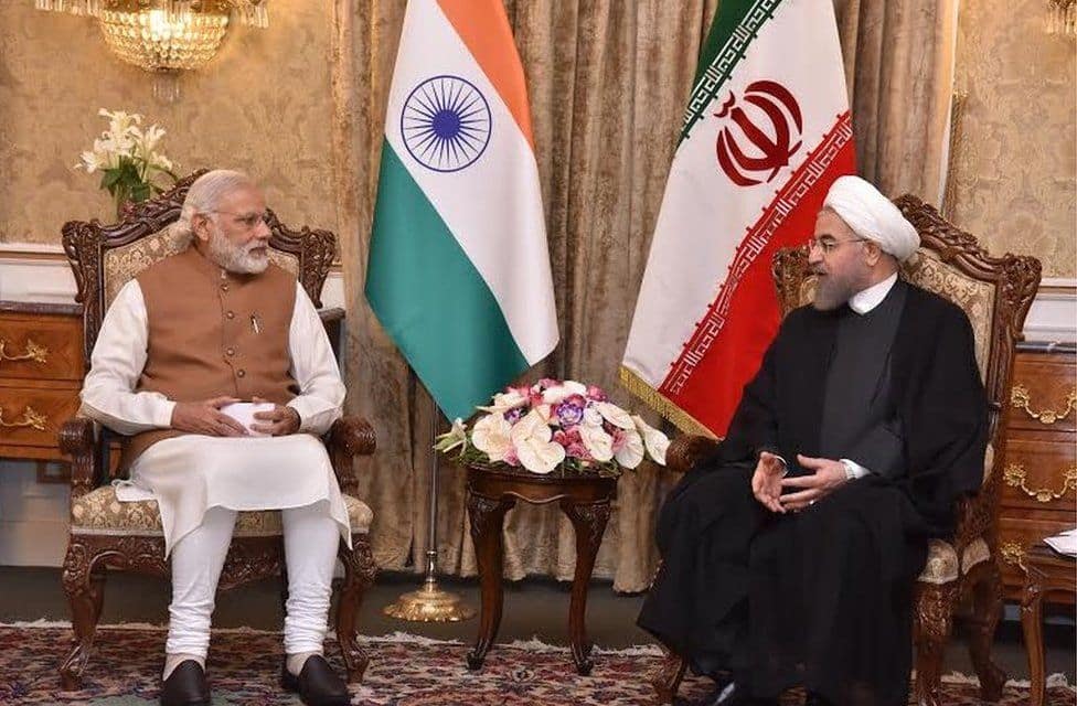 Officials from India and Iran shaking hands at the signing ceremony of the Chabahar port development agreement.